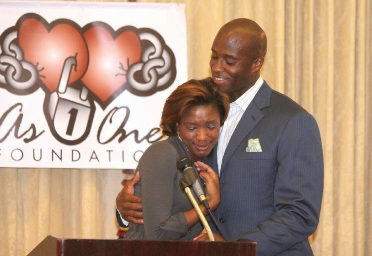 Devard Darling hugs his niece Rashayne Darling as she becomes emotional while speaking at the 4th Annual As One Foundation Devard and Devaughn Darling Scholarship Awards dinner at Sweetwater Country Club in Sugar Land.
