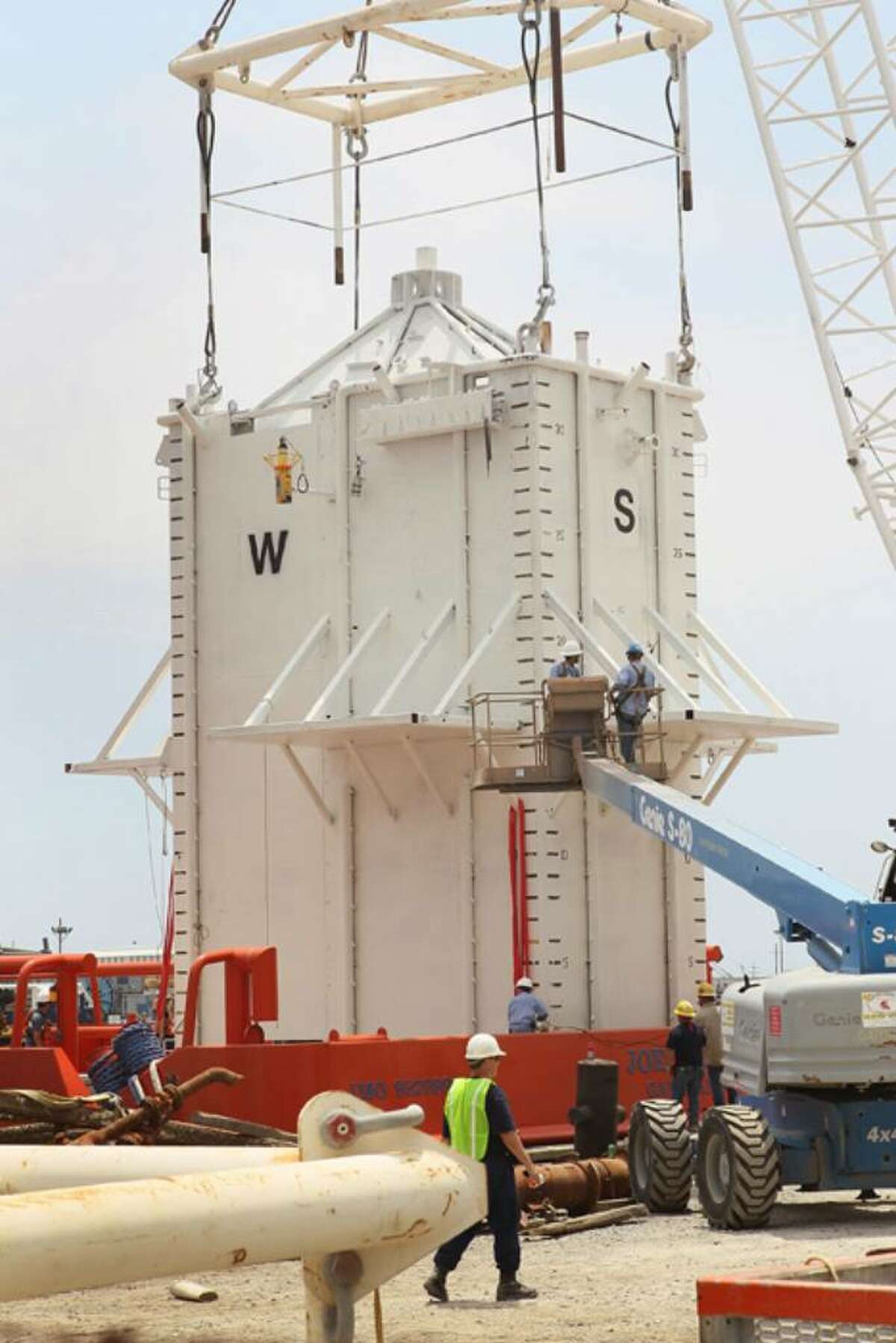 PORT FOURCHON, LA - MAY 05: A four-story 100-ton "pollution control chamber" which will be lowered 5,000 feet below the surface of the water to capture oil gushing from the collapsed oil well off the coast of Louisiana is loaded on the back of a ship May 5, 2010 in Port Fourchon, Louisiana. The chamber, commissioned by BP, is planned to be lowered onto the leaking pipe by end of the week to try to suck in the flowing oil to tanker ship on the surface. The Deepwater Horizon offshore oil well began leaking after the rig caught fire and collapsed last month. (Photo by Scott Olson/Getty Images)