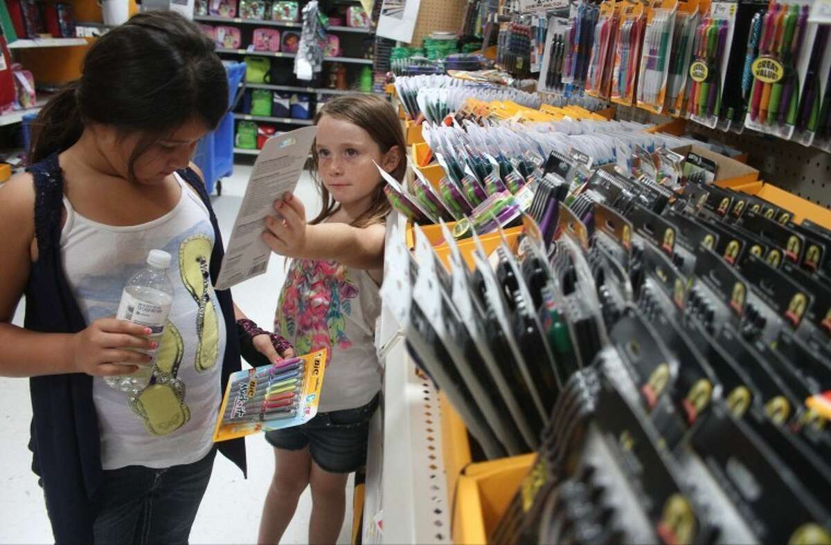 Jessica Shuff, bottom and her friend Mariah Batres check out school supplies at Walmart in Atascocita during tax-free weekend on August 17.