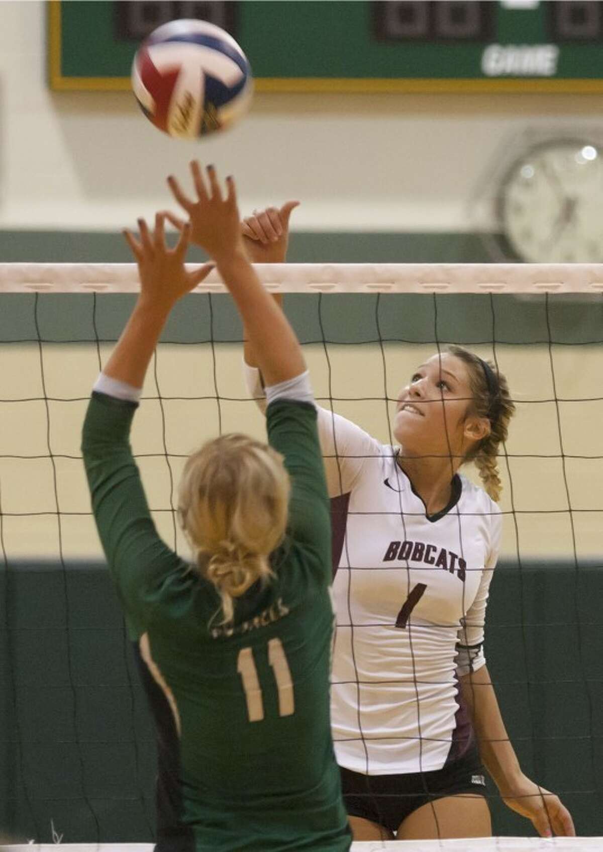 Cy-Fair's Lila Palmer spikes the ball over the net during the Lady Bobcats' match against Cy Falls on Tuesday at Cy Falls High School.