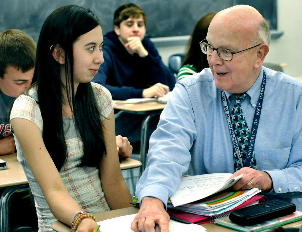 SPECTRUM/Soon-to-be retired teacher David Shaffer helps Victoria Asman, a senior, while instructing a math class at New Milford High School, April 6, 2010. He has announced his retirement for June.