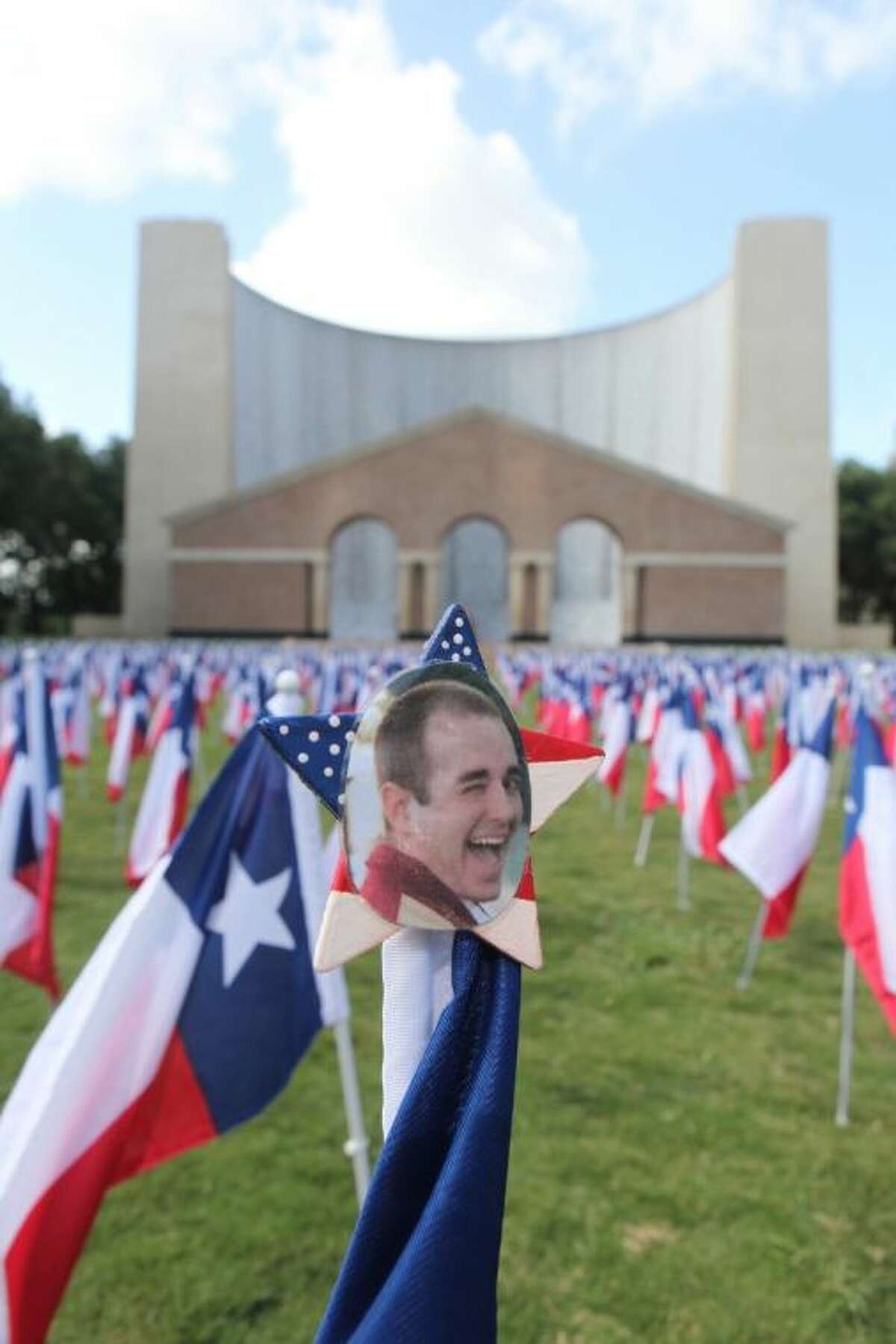 Aaron Pennywell's picture sits on top a Texas flag along with 1,170 Texas flags representing all the lives lost last year to drunk driving in front of the Gerald Hines Waterwall Park in Houston. Pennywell was killed by a drunk driver who ran a stop light and struck his vehicle on June 25, 2011.