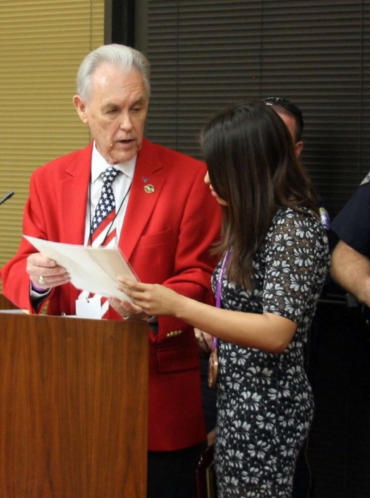 Richard Scott, director of community relations in Pasadena, is shown with Olympic medalist Marlen Esparza during an awards ceremony at a City Council meeting in 2012. On Tuesday, Scott testified in a voting rights lawsuit that he regretted breaking state ethics laws.