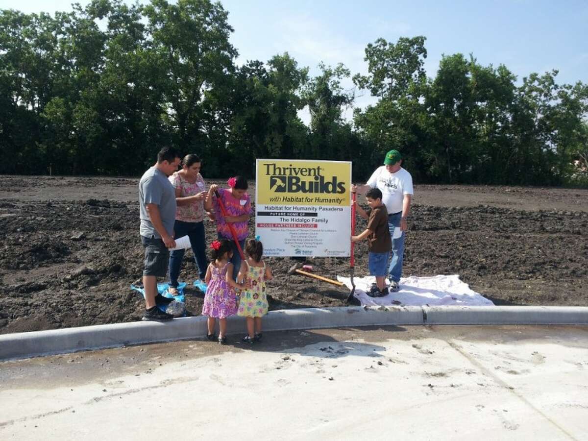 The Hidalgo Family participates in the groundbreaking with Pastor Kelly (Green Hat) from Peace Lutheran.