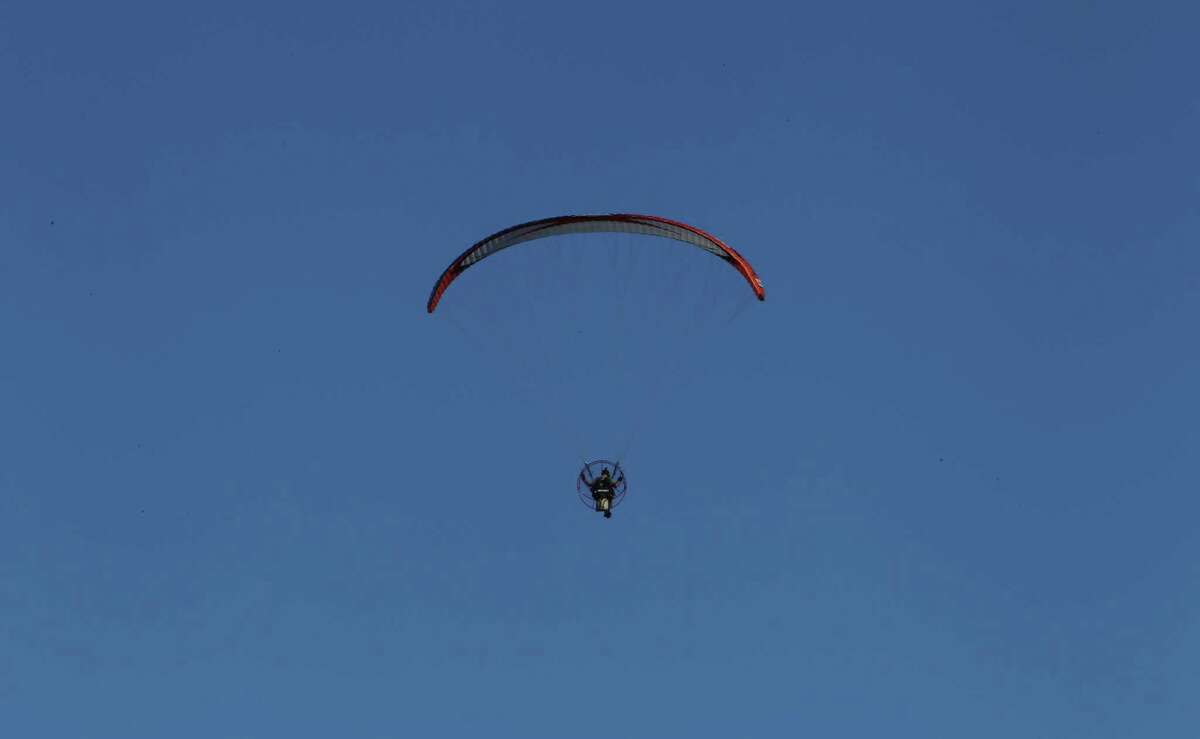 Flying by the seat of his paraglider