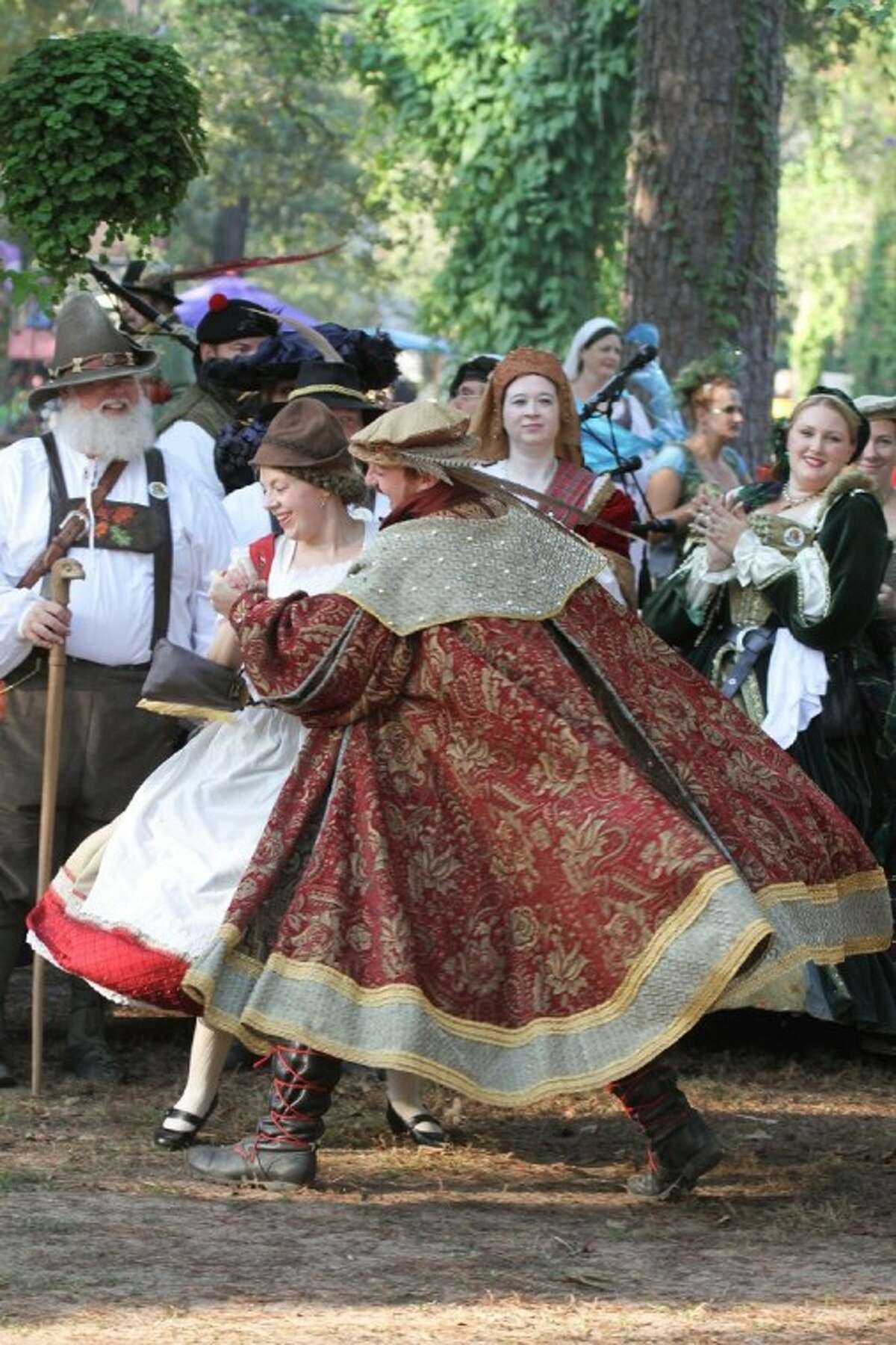 Jennie Zurovetz, aka Katarina Havener, Lady-in-Waiting, dances with Gregory Taylor, King of the Festival, at the Texas Renaissance Festival.