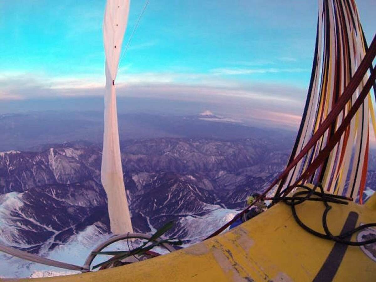 The helium-filled balloon carrying Troy Bradley and Leonid Tiukhtyaev passes over Mt. Fuji on Monday. The two pilots landed safely off the coast of Mexico early Saturday after an audacious, nearly 7,000-mile trip across the Pacific Ocean that shattered two long-standing records for ballooning.