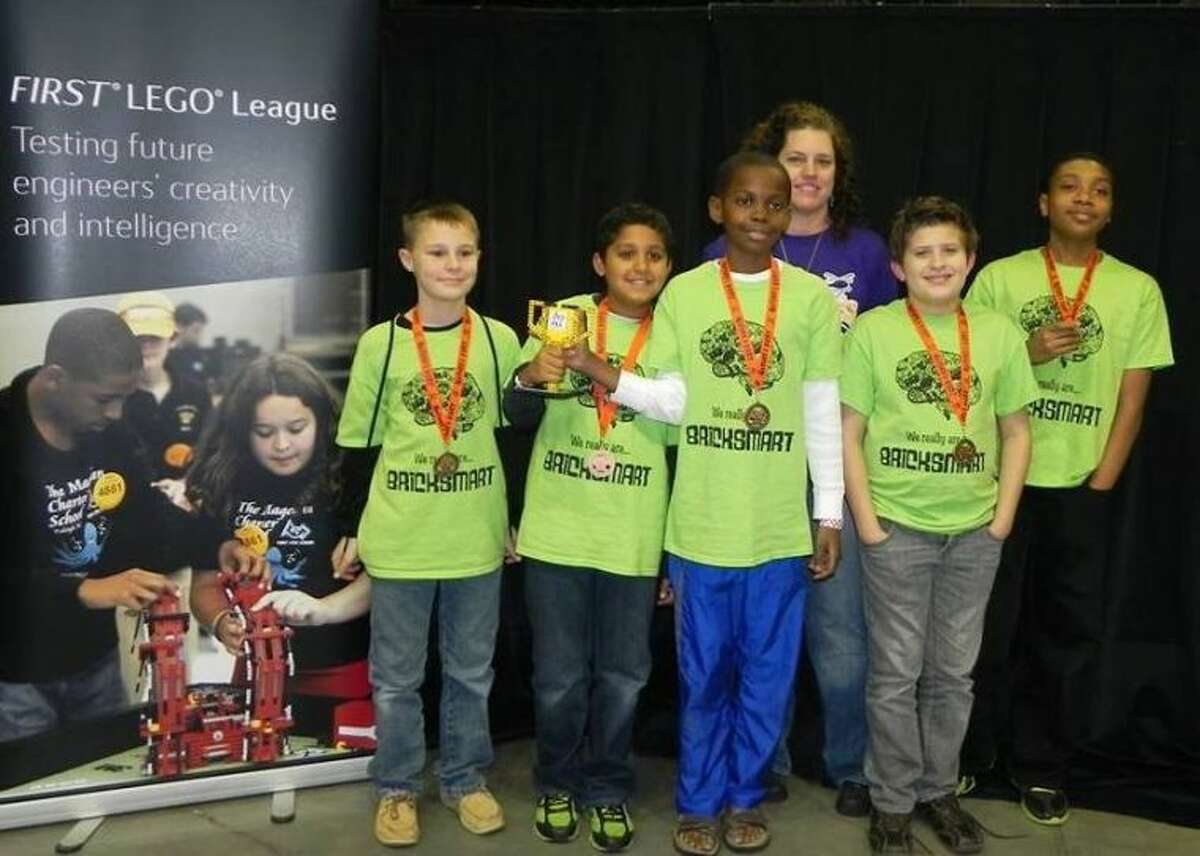 The BrickSmart team consists of five boys who attend different schools in The Woodlands, Magnolia and Conroe. From left to right are Weston Coleman, Kabir Jolly, Tani Bassir, Devin McGuyer and Tobi Soares, and their coach is Katie Kelley.
