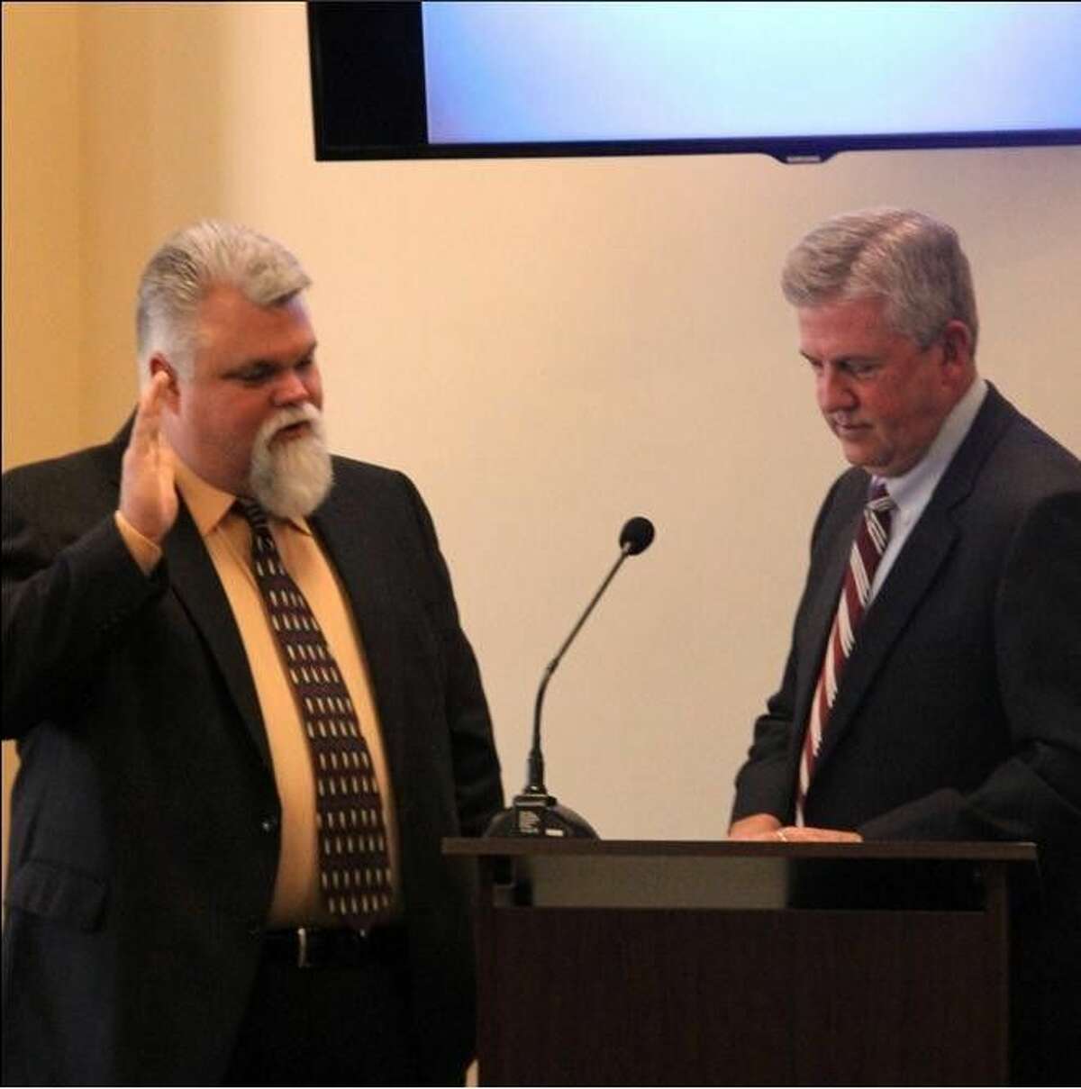 Gregg Hope, left, takes the oath of office from County Judge Craig Doyal as a member of the Lone Star Groundwater Conservation District Board of Directors. He replaces Sam Baker who resigned due to an increased workload.