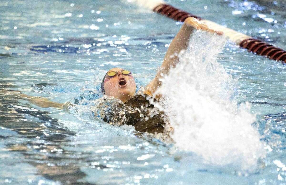 The Woodlands’ Lucie Nordmann swimming during the 100-yard backstroke at the UIL Region IV-6A Championships on Saturday. Nordmann set a new school record, and placed first in the competition during the event.