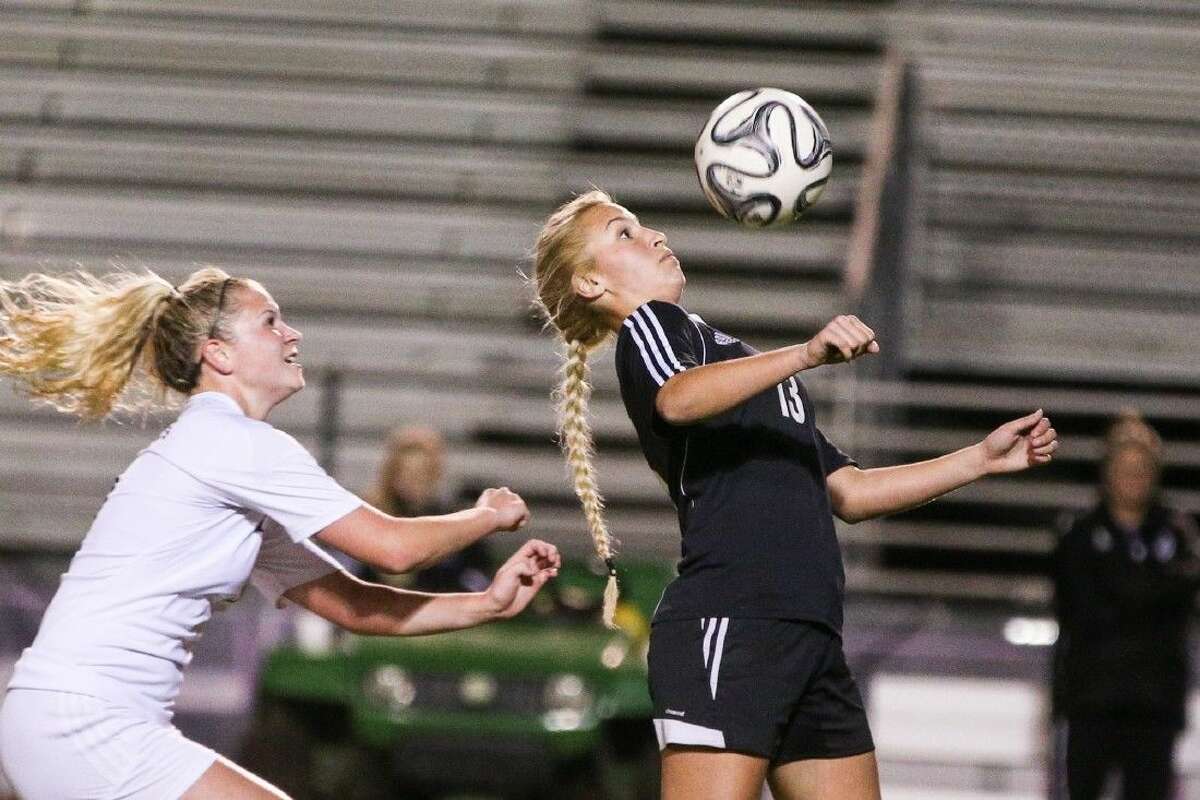 Conroe's Sarah Stevenson (13) heads the ball during the high school girls soccer game against Willis on Tuesday, January 19, 2016, at Lynn Lucas Middle School. To view more photos from the game, go to HCNPics.com.