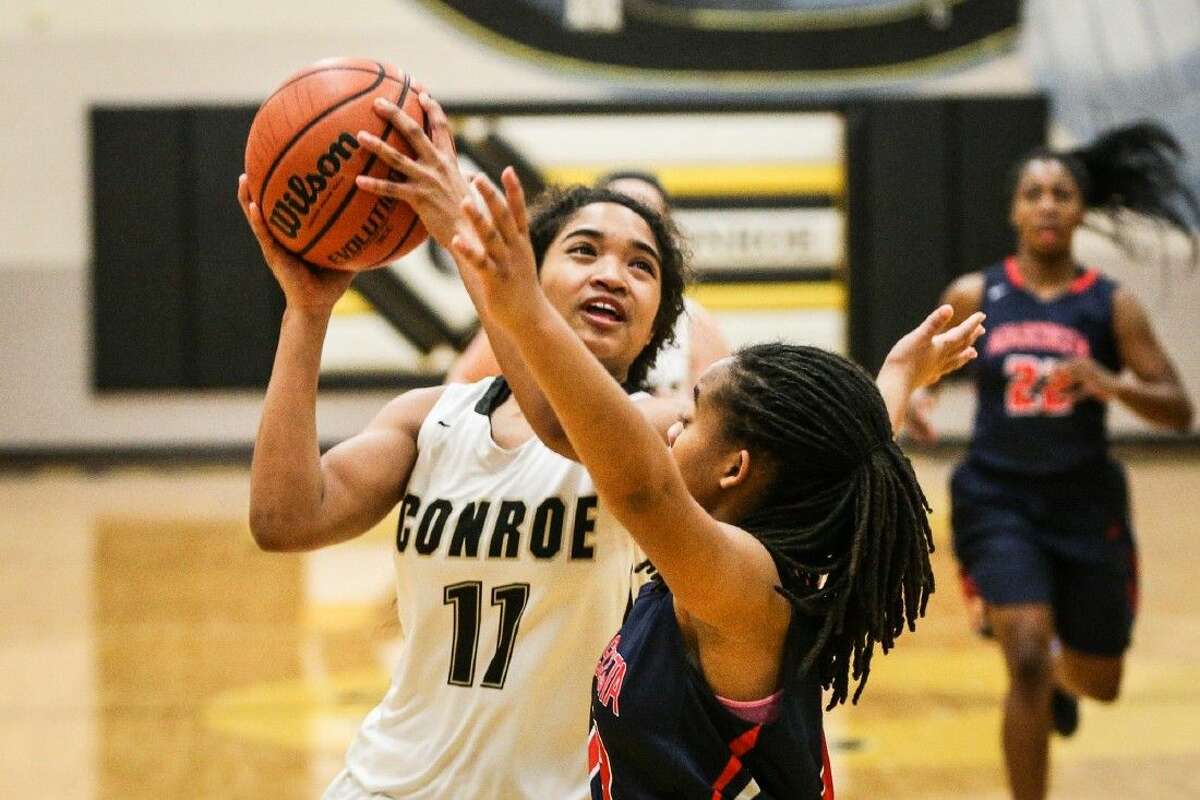 Conroe's Jznae Kim (12) goes for a layup during the high school girls basketball game against Atascocita on Tuesday, January 19, 2016, at Conroe High School. To view more photos from the game, go to HCNPics.com.