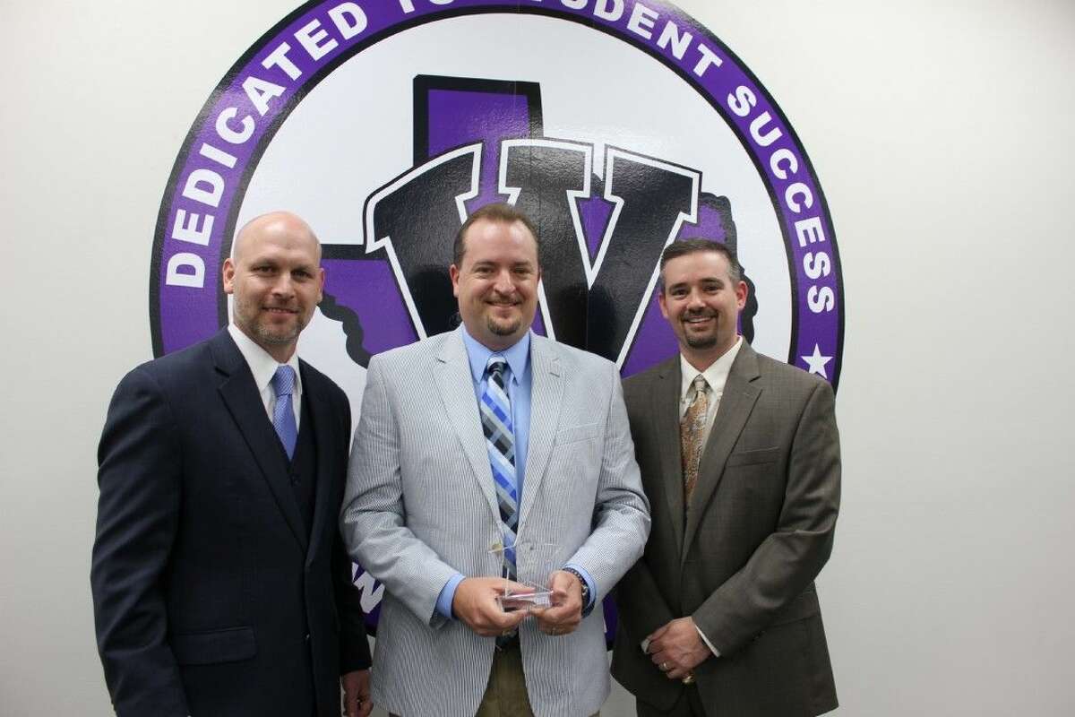 Ken Labonski, center, receives the February MVP award from Willis ISD Superintendent Tim Harkrider, left, and Willis High School Principal Travis Utecht.