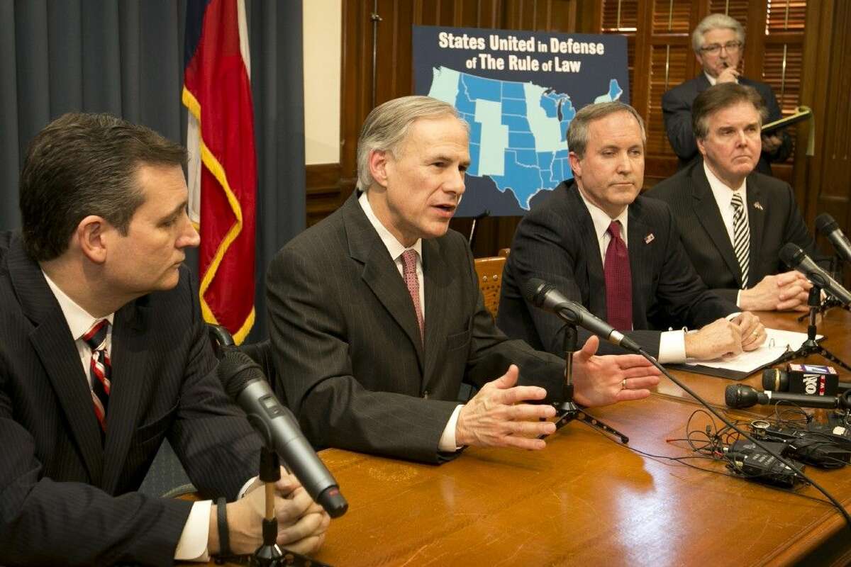 From left, Texas Sen. Ted Cruz, Gov. Greg Abbott, Attorney General Ken Paxton and Lt. Gov. Dan Patrick talk about President Obama’s executive actions on immigration Wednesday in Austin.