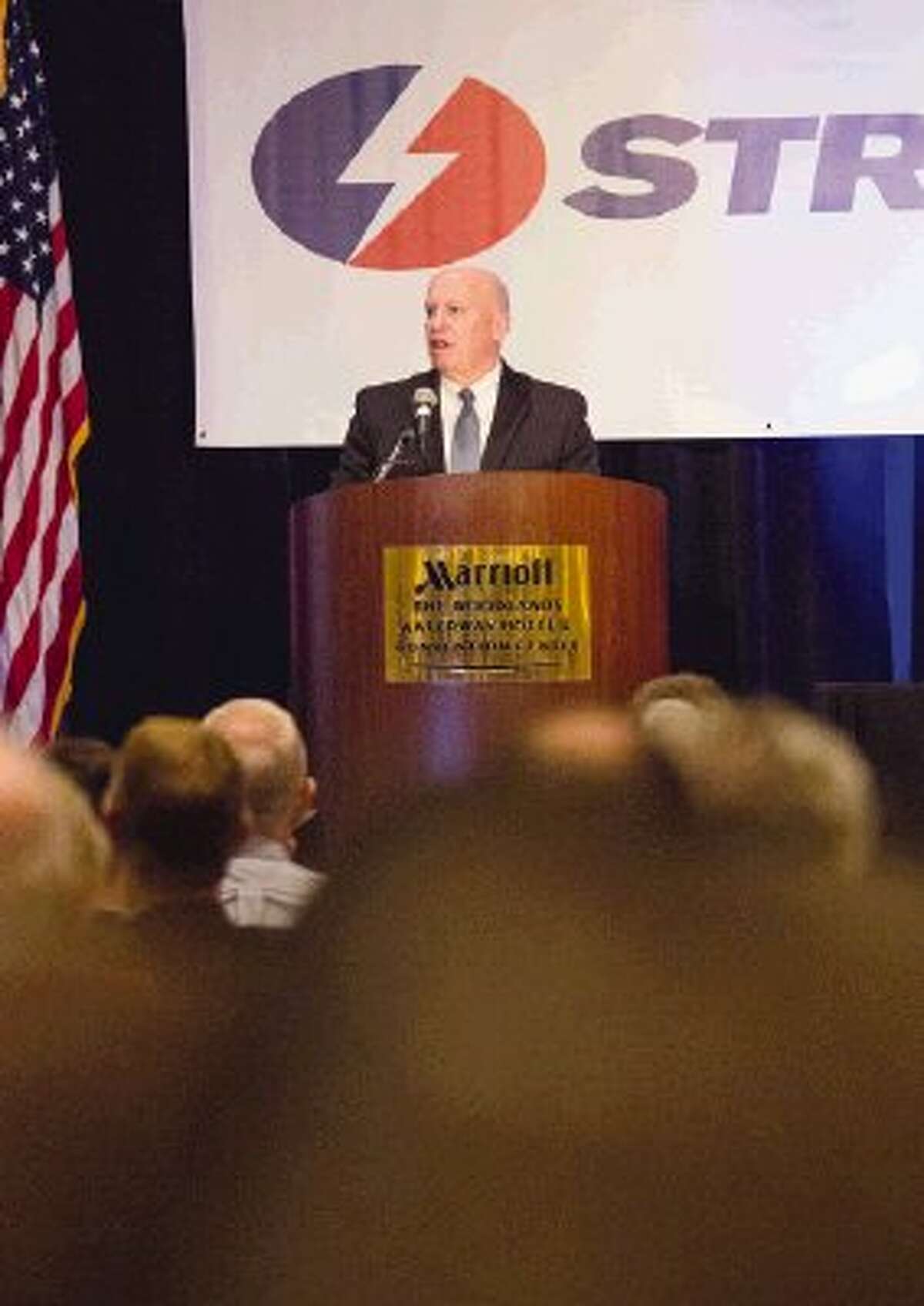 U.S. Representative (R-The Woodlands) Kevin Brady kicks off The Woodlands Area Chamber of Commerce’s 28th Annual Economic Outlook Conference themed for 2014, “Energy to Grow” on Friday during The Woodlands Waterway Marriott Hotel & Convention Center. The conference was presented by Strike energy services provider as depicted on the banner behind Congressman Brady.
