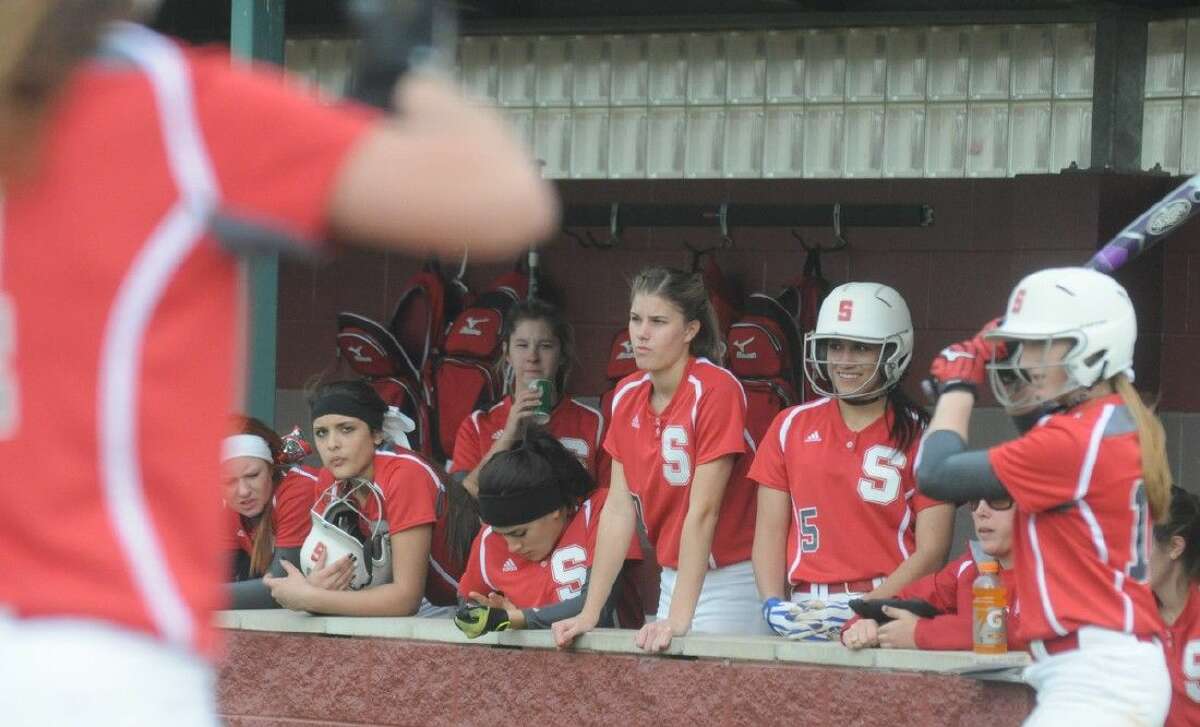 Members of the Splendora softball team watch from the dugout while at bat against Dayton at the Willis Tournament on Thursday.