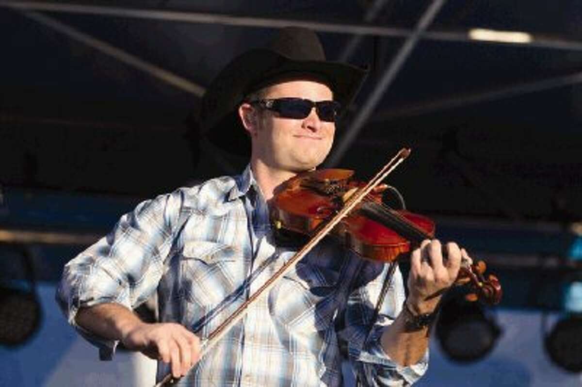 John Slaughter sings and plays a violin during “Boogie on the Blacktop” Saturday in downtown Conroe’s Heritage Park. Beer, food and rides were also offered during the event. To view or purchase this photo and others like it, visit HCNpics.com.