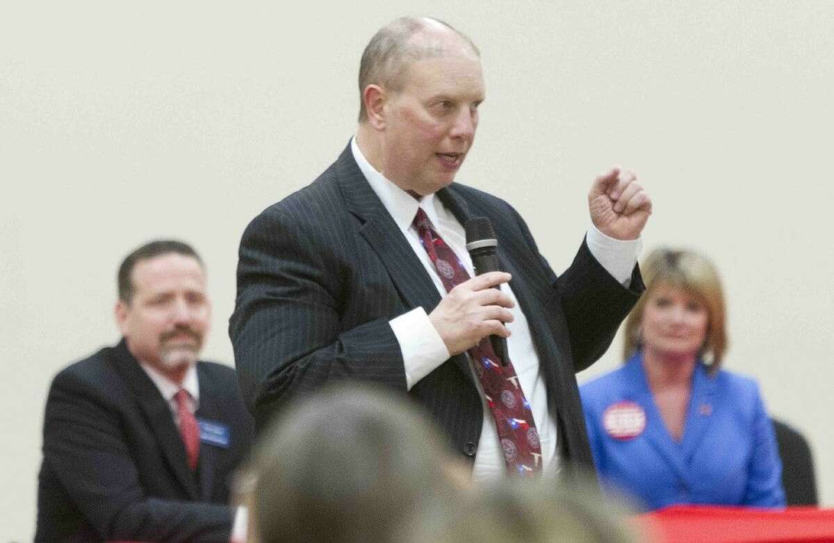 Eric Yollick, candidate for 9th state District Court, speaks as Phil Grant and Kate Shipman Bihm look on during a Republican primary candidate forum put on by the North Shore Republican Women Thursday.