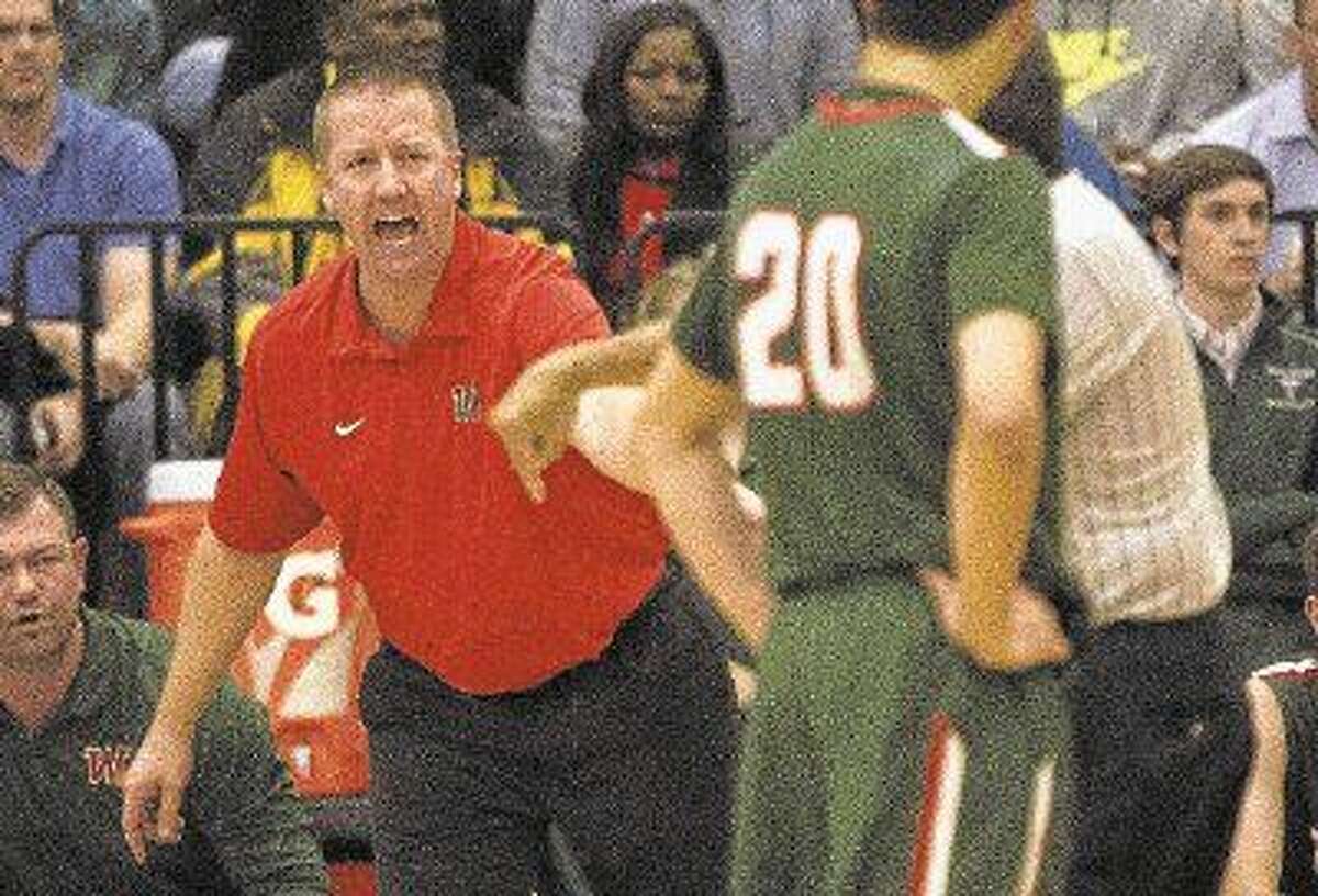 The Woodlands head coach Dale Reed argues a call during the second quarter of a basketball game at Atascocita High School Tuesday, Jan. 5, 2015. To purchase this photo and others like it, go to HCNpics.com.