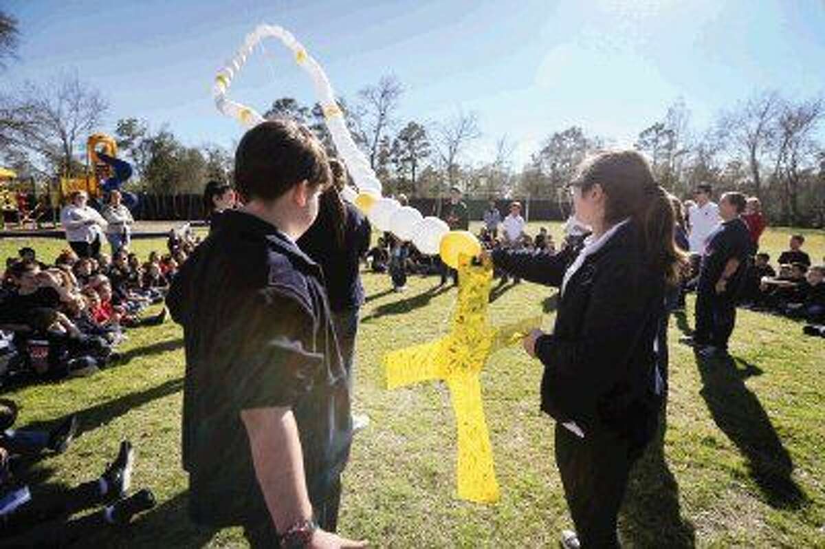 Students of Sacred Heart Catholic School release a series of balloons shaped like a rosary while celebrating National Catholic School Week on Wednesday in Conroe.