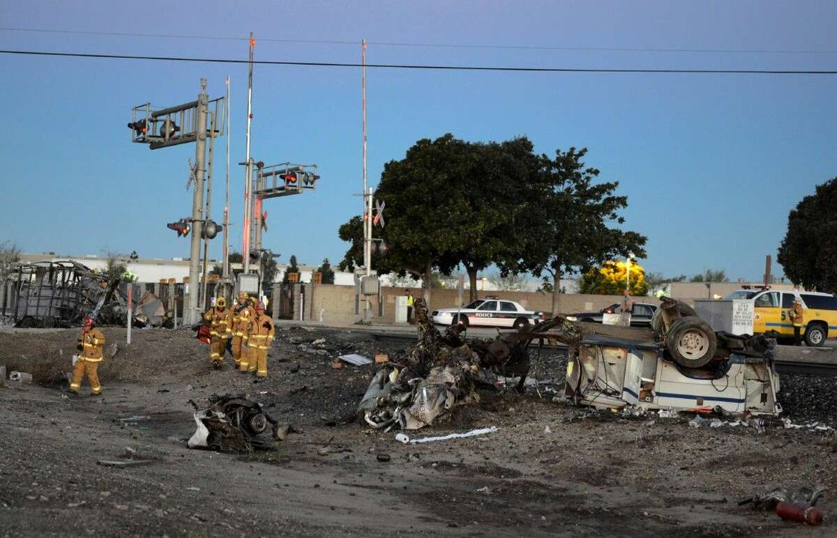 Firefighters arrive to attend to injured passengers at the scene of a Metrolink accident Tuesday in Oxnard, Calif.
