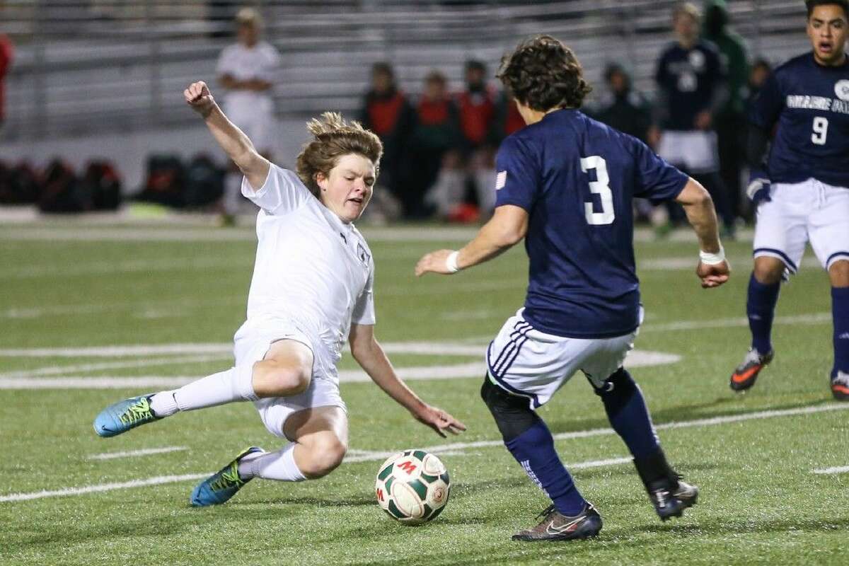 The Woodlands’ Kody Korell (3) tries to get past College Park’s Christopher Molina (3) during the high school boys soccer game on Friday at Woodforest Stadium.