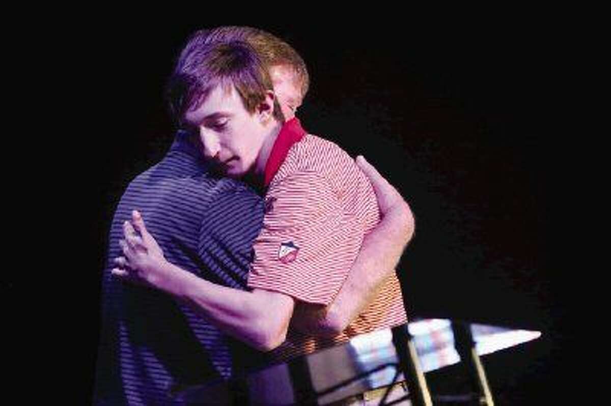 Zach Hamm, who is diagnosed with Ectodermal Dysplasias, hugs his father Paul before speaking during the Men’s Power Lunch series on Monday at Conroe First Baptist Church.