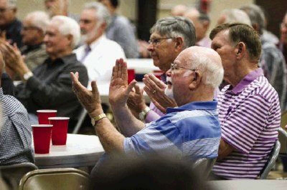 Audience members applaud as Bill Brown, Astros baseball announcer since 1987, speaks during the Men’s Power Lunch series on Monday at Conroe First Baptist Church.