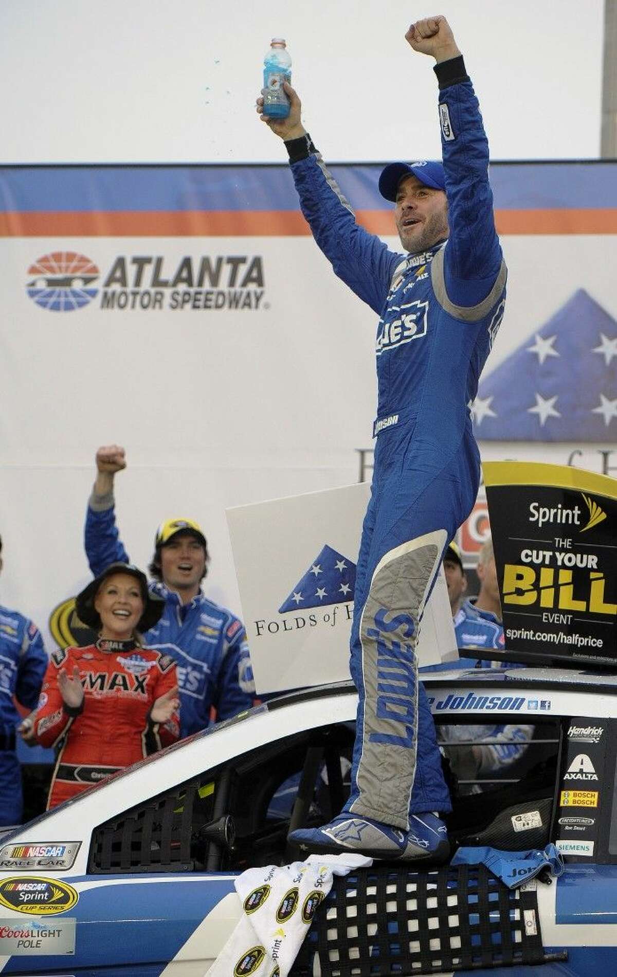 Jimmie Johnson reacts after winning the NASCAR Sprint Cup auto race at Atlanta Motor Speedway.