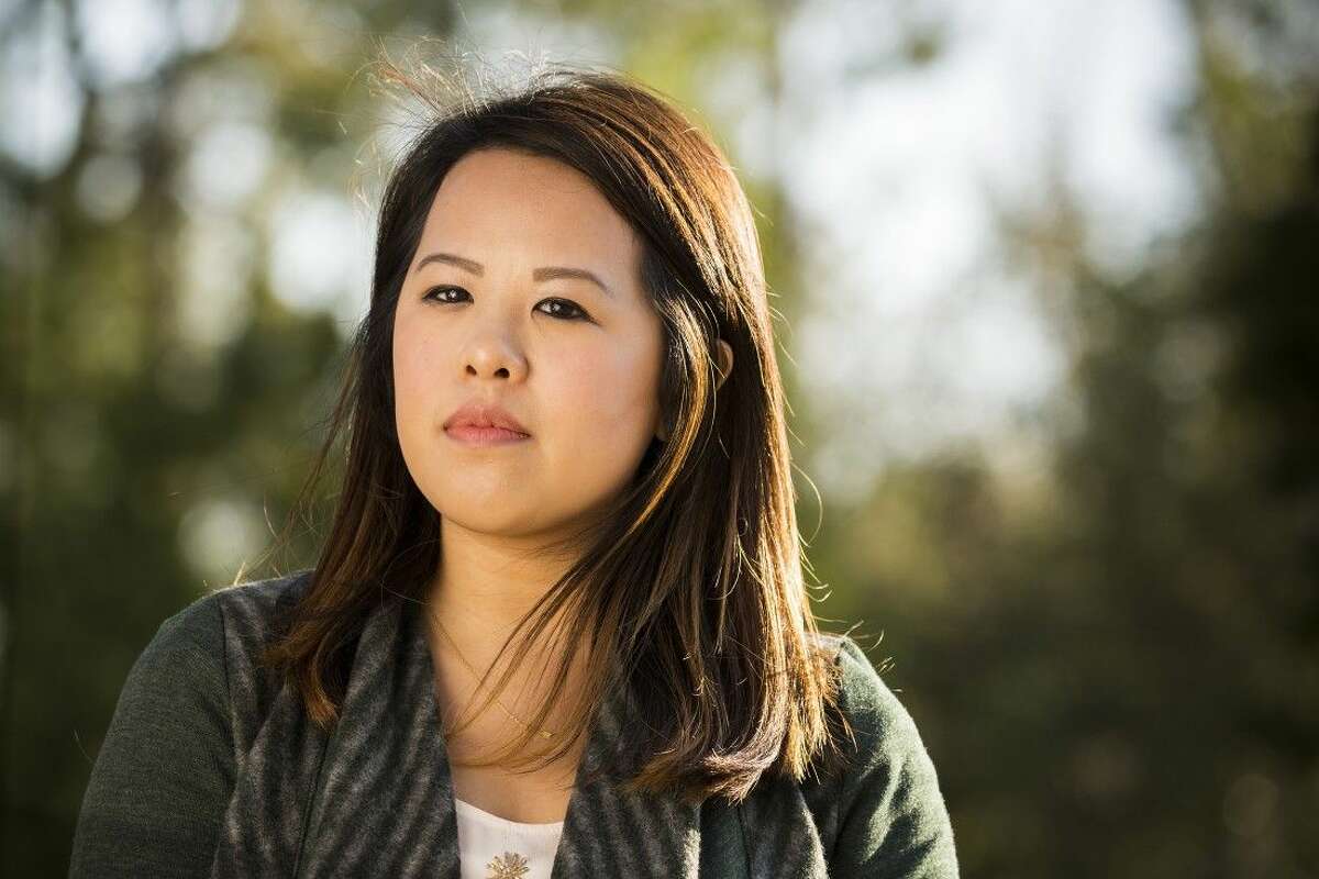 In this Feb. 25, photo, Ebola survivor Nina Pham poses for a photo in Dallas. Pham told The Dallas Morning News in the interview that she is preparing to file a lawsuit today in Dallas County against Texas Health Resources. She said she continues to suffer from body aches and insomnia after contracting the disease from a patient she cared for last fall at Texas Health Presbyterian Hospital Dallas.