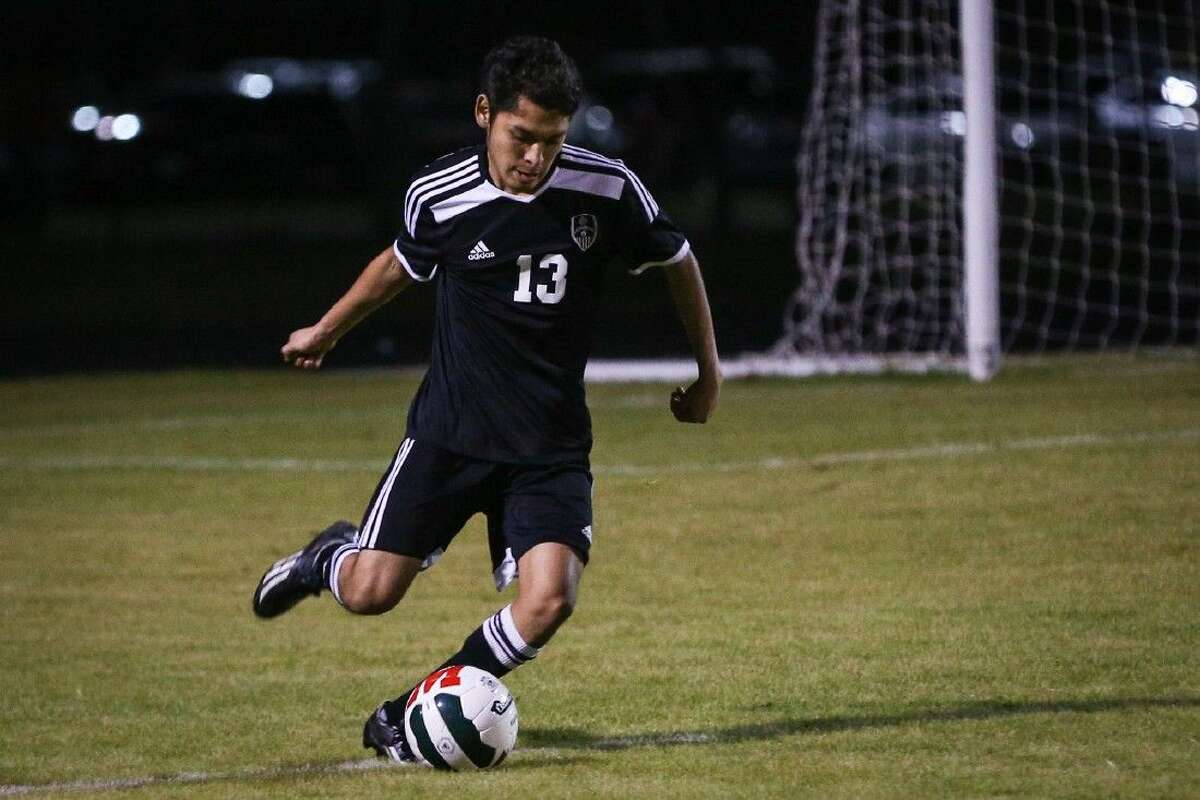 Conroe’s Jorge Navarrete (13) kicks the ball during a game against The Woodlands on Tuesday at The Woodlands High School. To view more photos from the game, go to HCNPics.com.