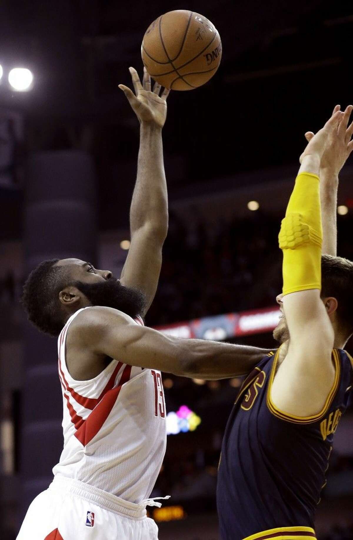 Rockets guard James Harden, left, pushes against the Cleveland Cavaliers' Matthew Dellavedova. The Rockets won 105-103.