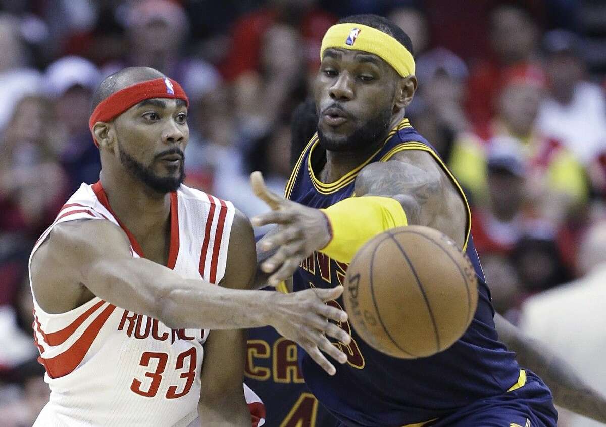 The Cleveland Cavaliers' LeBron James, right, tries to block a pass by Houston Rockets' Corey Brewer. The Rockets won 105-103.