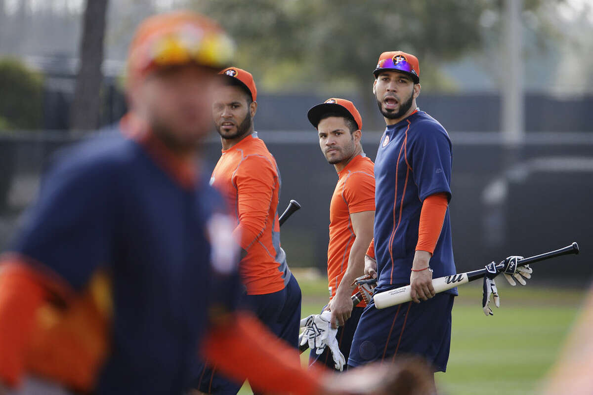 Houston Astros' Gregorio Petit, from left, Jose Altuve and Marwin Gonzalez walk on the field during a spring training baseball workout as Astros position players officially report today, Tuesday, Feb. 24, 2015, in Kissimmee, Fla. (AP Photo/David Goldman)