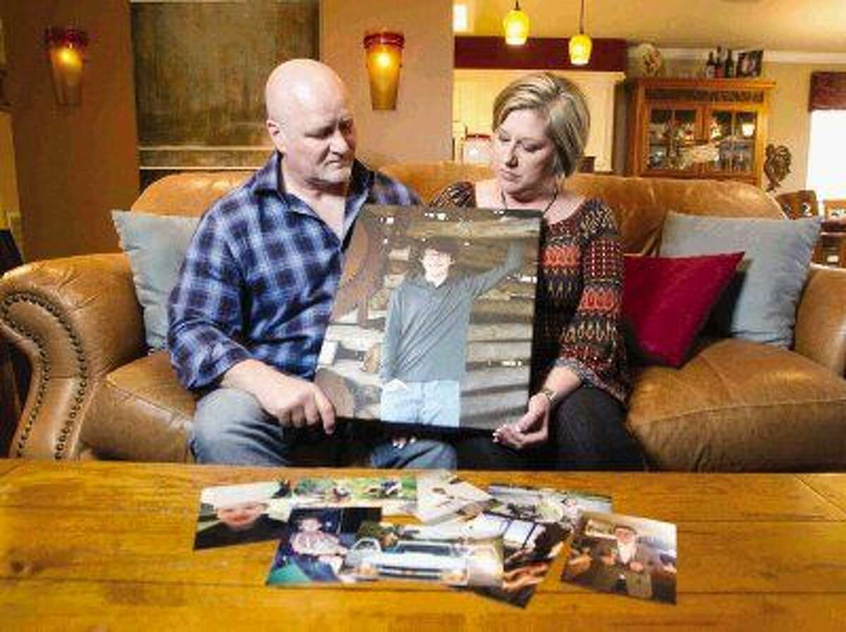 Tyler and Traci Hobson look at a portrait of their son, Grant, who died after ingesting synthetic LSD. The Hobsons are trying to raise awareness of the drug’s dangers.