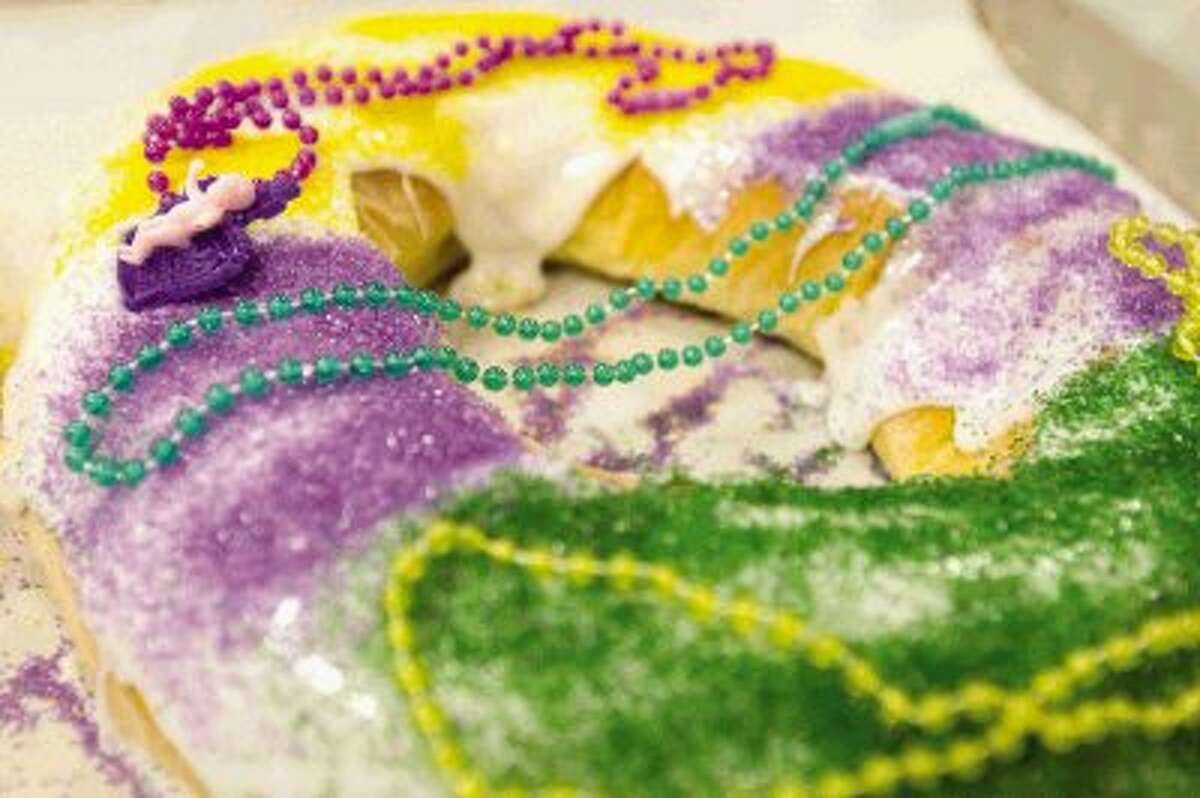 A finished Mardi Gras king cake waits to be boxed up for customers at Montgomery Bakehouse in Conroe Tuesday.