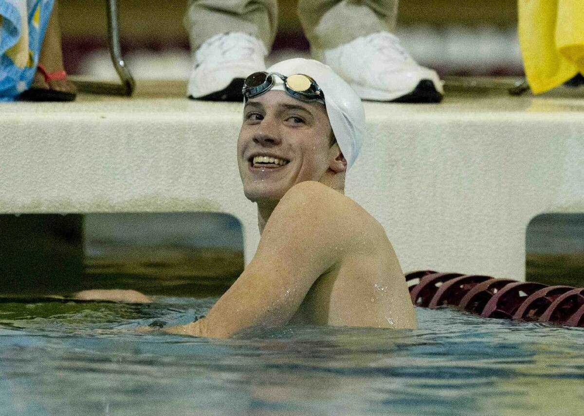 Oak Ridge's Zachary Hansen smiles after competing in the boys 100-yard backstroke during a District 16-6A swimming and diving championship meet Saturday, Jan. 23, 2016. To purchase this photo, and other like it; go to HCNpics.com.