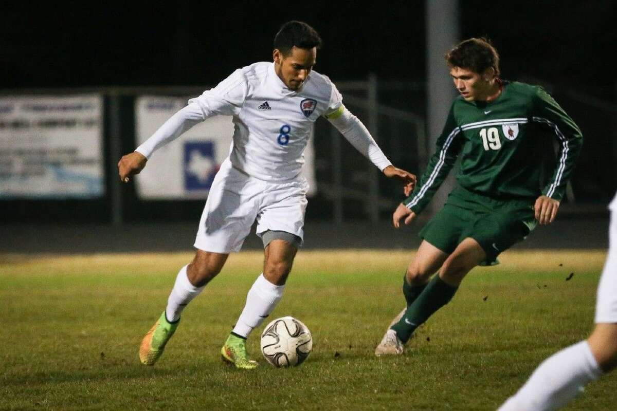 Oak Ridge’s Marcos Chavez (8) tries to get past The Woodlands’ Liam Smyth (19) during the high school boys soccer game on Friday at Oak Ridge High School.