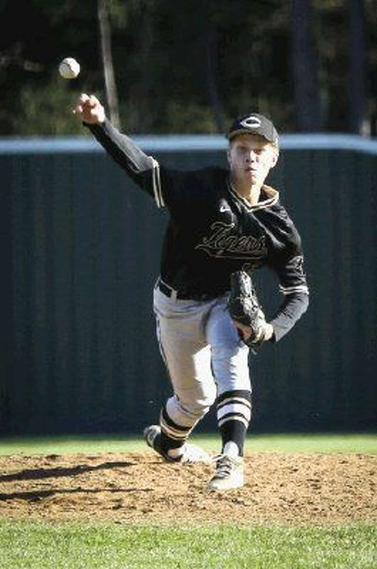Conroe's Wesley Johnson (19) throws a pitch against Cy-Fair. To view more photos from the game, go to HCNPics.com.
