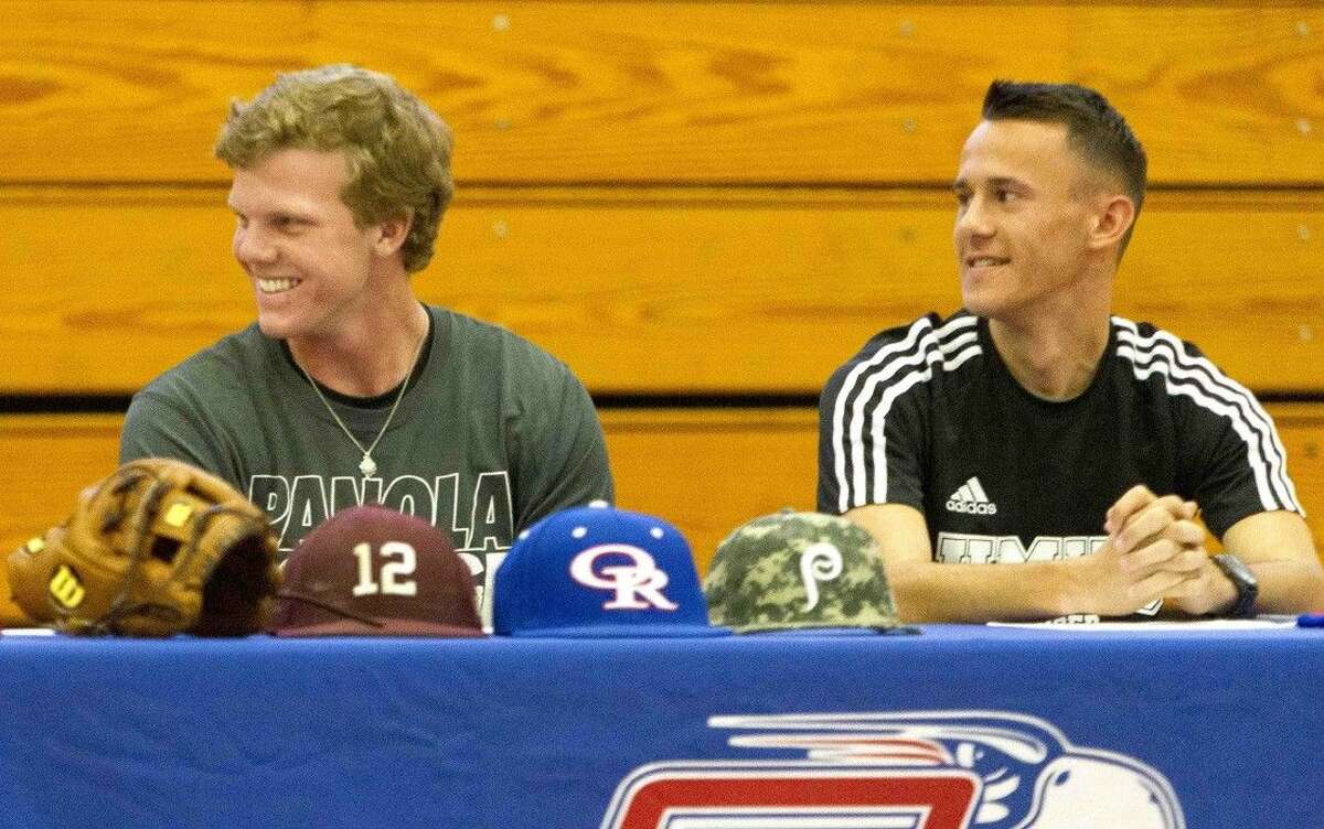 Oak Ridge's Michael Lawson, left, reacts along side Logan Aucoin as Justin Alphonse, not pictured, celebrates during a signing day ceremony Wednesday. Lawson signed to play baseball at Panola Jr. College, while Aucoin signed to play soccer with Mary Hardin-Baylor.