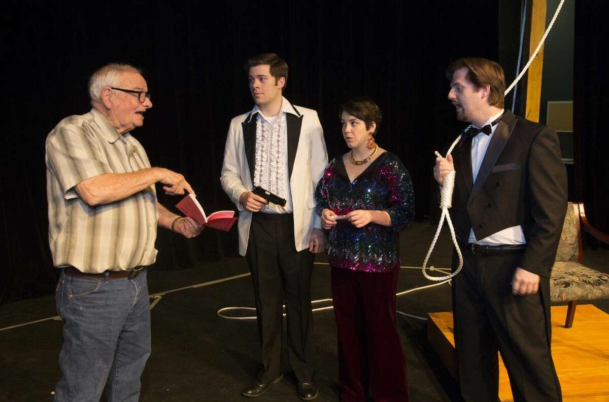 From left director Jim Walker, works with Nick Hough, Sarah Walker and Brian Heaton while rehearsing for “Murder at The Howard Johnson’s.”