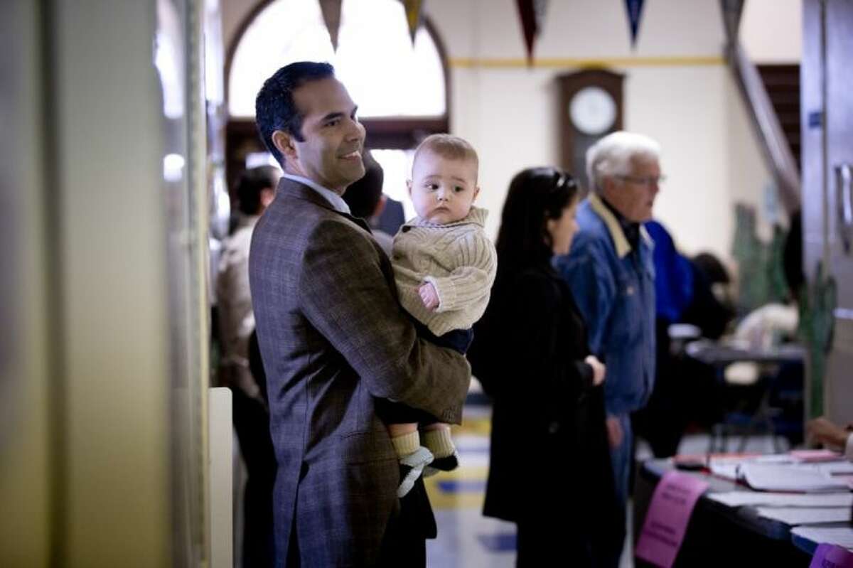 George P. Bush, holding his with son Prescott, turned out to vote in the primary election Tuesday at North High Mount Elementary School in Fort Worth, Texas. The 37-year-old nephew of former President George W. Bush, and son of former Florida Gov. Jeb Bush, is running for land commissioner in the state.