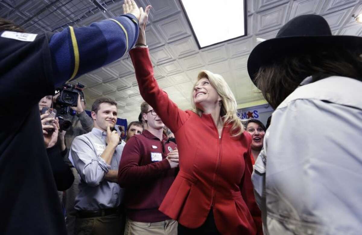 Texas Sen. Wendy Davis, D-Fort Worth, gets a high-five from a supporter after speaking at her campaign headquarters Tuesday in Fort Worth. Davis won the Democratic primary to run for Texas governor.