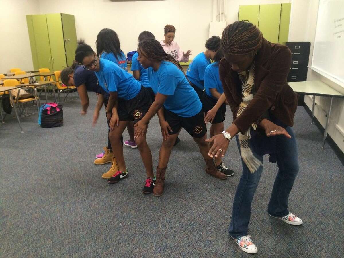 CHS Fierce Diamonds step coach Inyang Ekong guides steppers through their routine during practice.