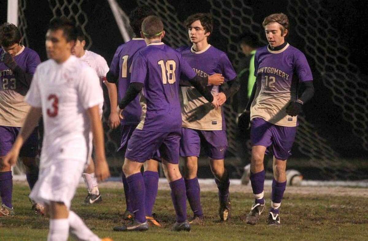 Teammates congratulate Montgomery’s Tyler Nenninger after he scored in the second half during a District 39-4A match against Caney Creek on Wednesday in Grangerland. To view or purchase this photo and others like it, visit HCNpics.com.
