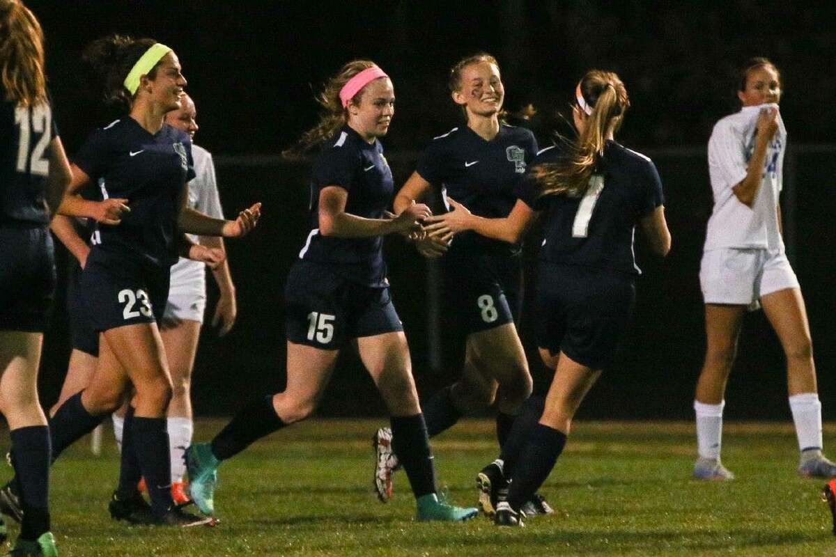 College Park’s Katie Rabold (15) celebrates with teammates after scoring a goal during the high school girls soccer game against Oak Ridge on Friday at Oak Ridge High School. To view more photos from the game, go to HCNPics.com.