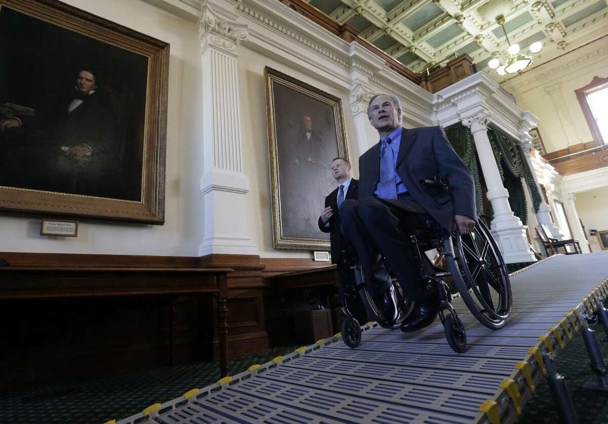 Texas Gov. Greg Abbott exits the Senate Chamber using a temporary ramp Jan. 5 in Austin.