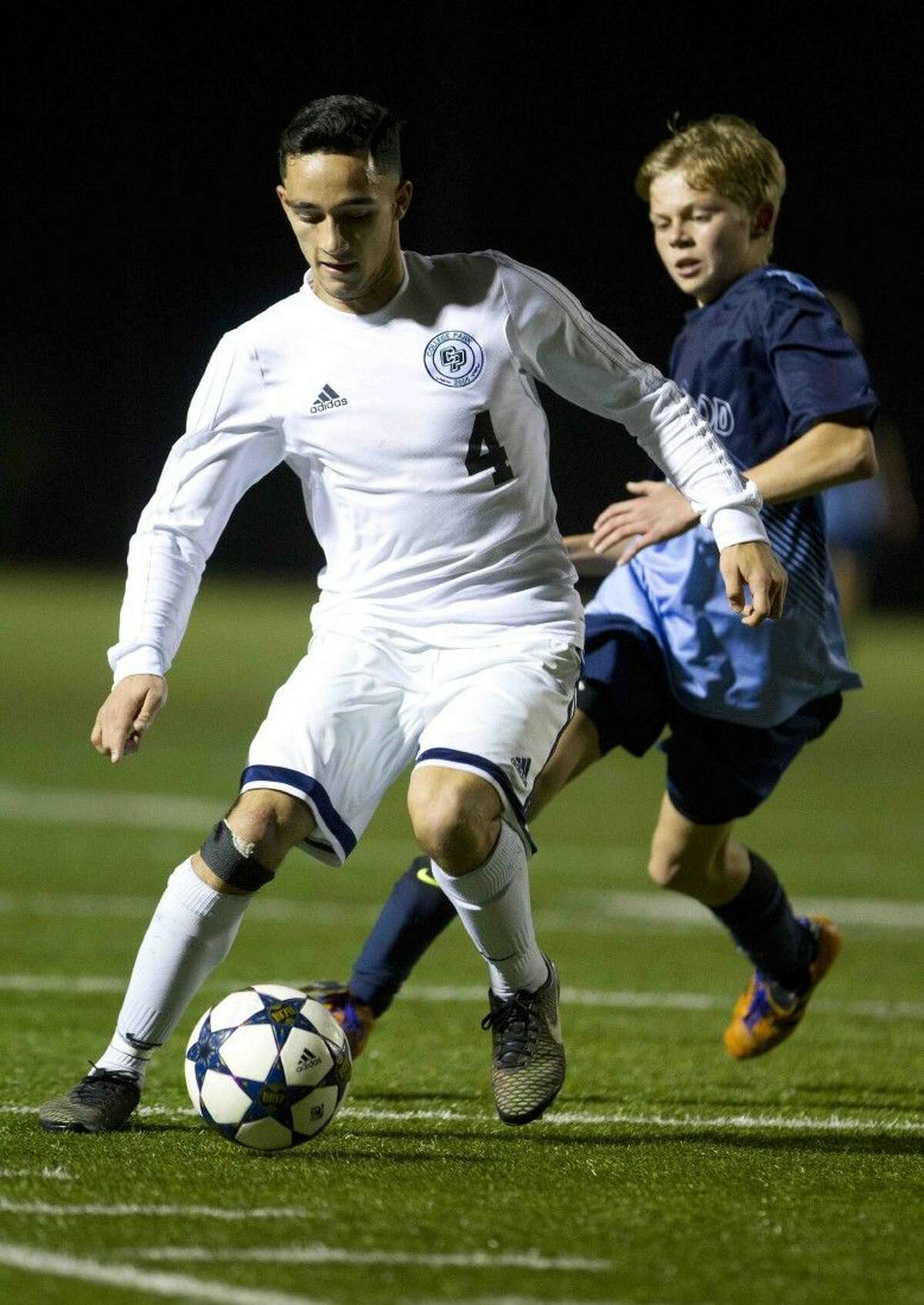 College Park's Samuel Molina looks to control the ball as Kingwood's Thomas Ditges defends during a high school soccer game Friday. To view or purchase this photo and others like it, visit HCNpics.com.