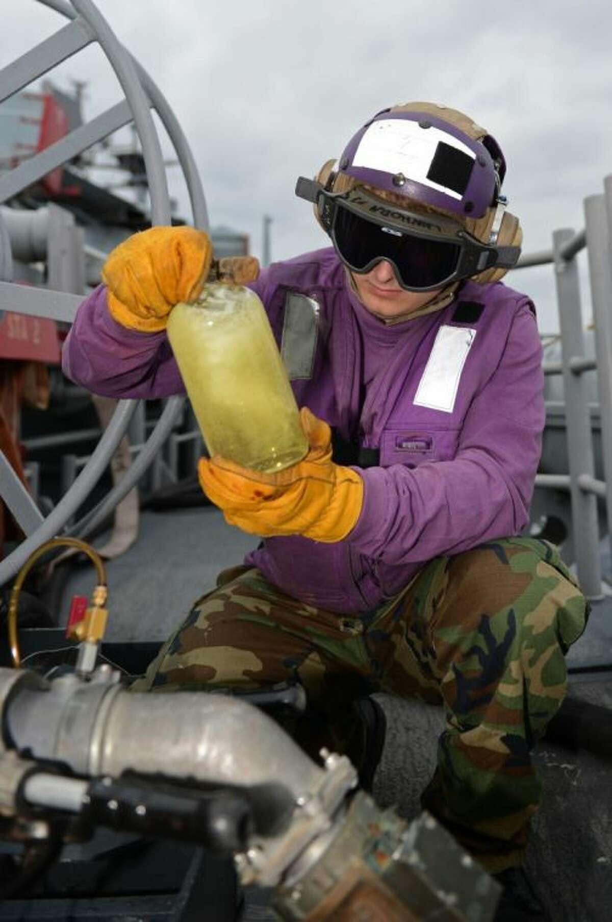 Aviation Boatswain’s Mate (Fuels) Airman Dylan Nunez, from Conroe, conducts a fuel clarity and brightness test with flushed JP 5 fuel March 3 somewhere in the East China Sea aboard the forward-deployed amphibious assault ship USS Bonhomme Richard (LHD 6). The Bonhomme Richard is the flagship of the Bonhomme Richard Amphibious Ready Group, and with the embarked 31st MEU, is currently conducting joint force operations in the U.S. 7th Fleet Area of Responsibility.