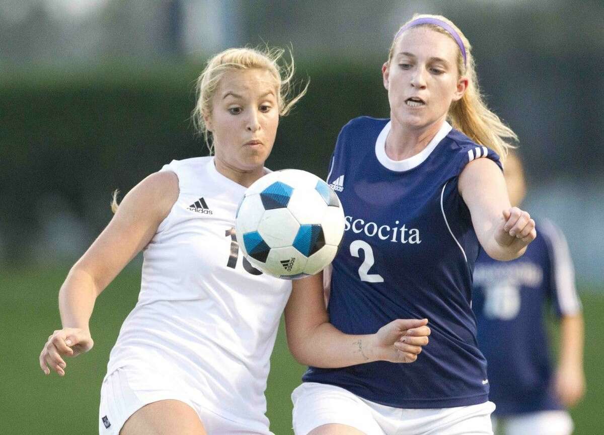 Conroe’s Sarah Stevenson and Atascocita’s Cassie Guest look to control the ball during a high school soccer game Friday.